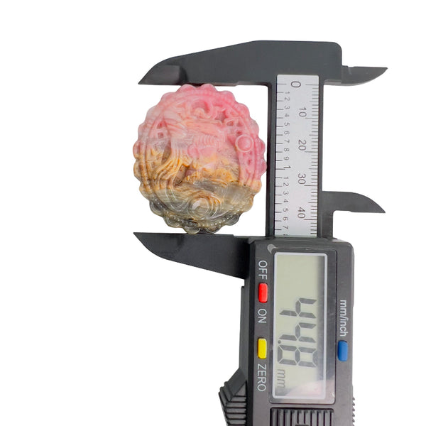 Pink Rhodonite Crystal Carving in Palm Showing Size Reference