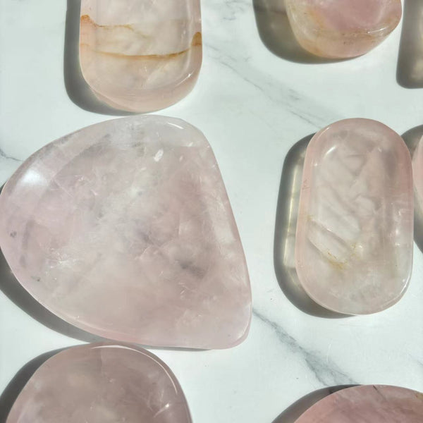 Light refraction through translucent rose quartz crystal bowl