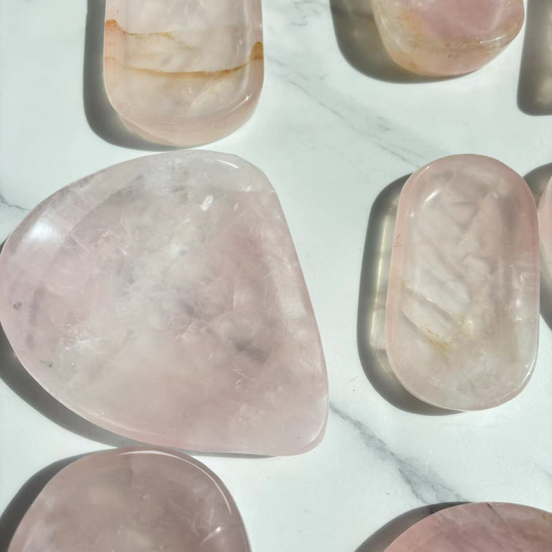 Light refraction through translucent rose quartz crystal bowl
