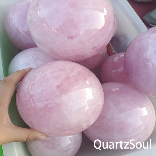 Rose quartz sphere showcasing natural patterns and wholesale quality