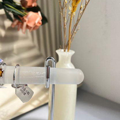 Selenite crystal ring holder shown at angle with jewelry