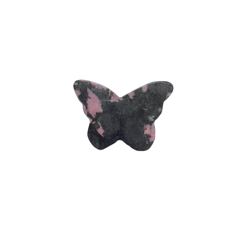 Rhodonite butterfly crystal carving displayed on altar setting for spiritual healing