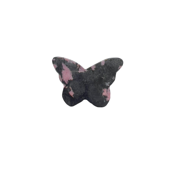 Rhodonite butterfly crystal carving displayed on altar setting for spiritual healing