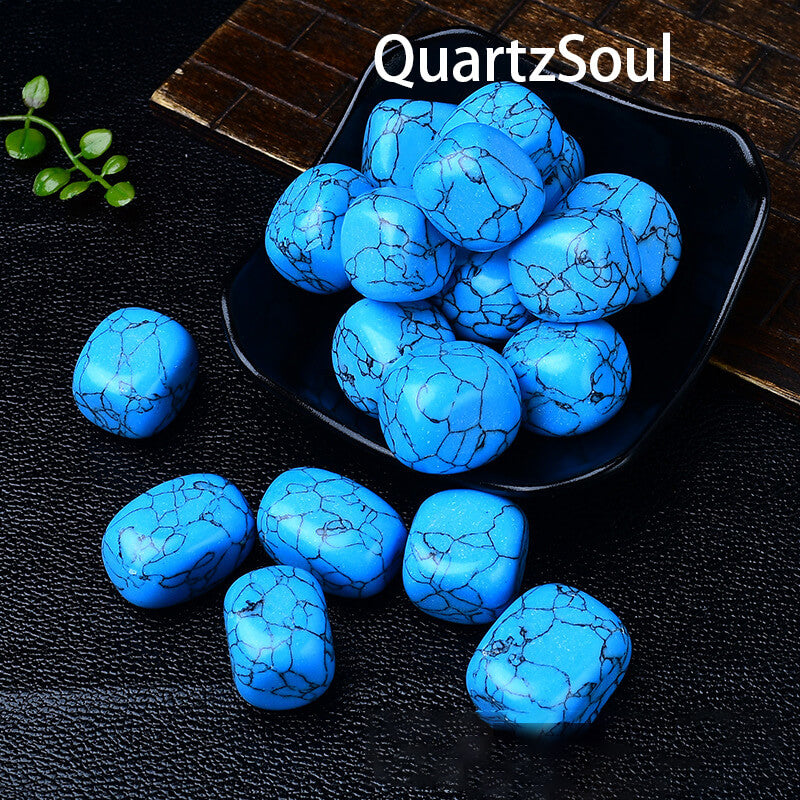 Polished blue turquoise tumbled stones arranged in black display dish showing matrix veining