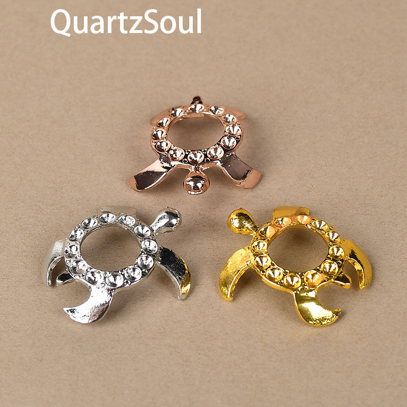 Elegant turtle-shaped crystal ball stands in gold, silver and rose gold finishes with rhinestone accents