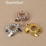 Elegant turtle-shaped crystal ball stands in gold, silver and rose gold finishes with rhinestone accents