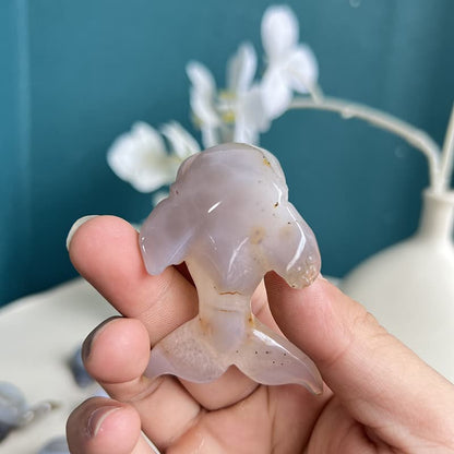 White agate crystal dolphin carving viewed from side angle