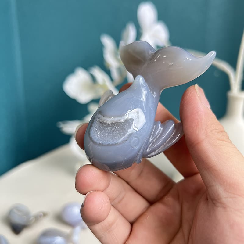White agate whale crystal displaying beautiful translucency when held to light