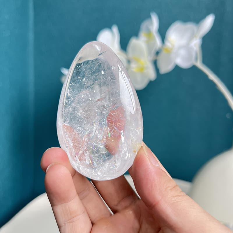 White Smoky Quartz Crystal Egg in Meditation Setup with Candles