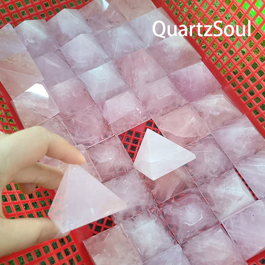 Premium wholesale rose quartz pyramids arranged on red display grid