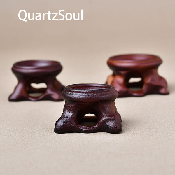 Set of three wooden crystal ball stands in different sizes for displaying mineral spheres