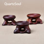 Set of three wooden crystal ball stands in different sizes for displaying mineral spheres