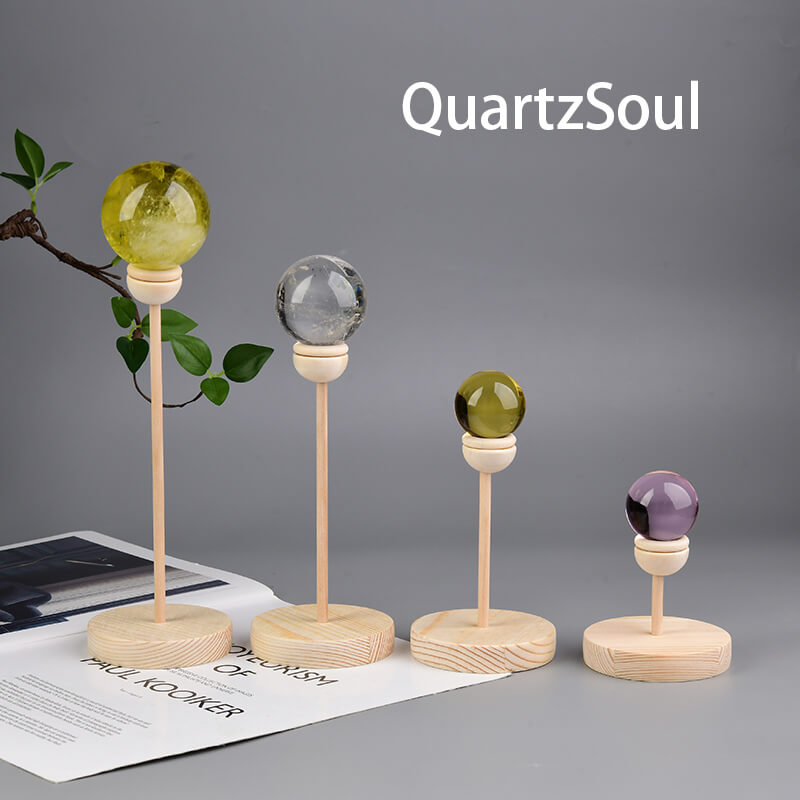 Handcrafted wooden crystal ball stands in various heights with colorful crystal spheres