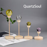Handcrafted wooden crystal ball stands in various heights with colorful crystal spheres