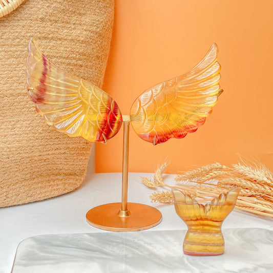 Amber crystal angel wings on gold stand for spiritual healing practice and home decor