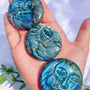 Labradorite face carving with blue flash displaying spiritual crystal artwork