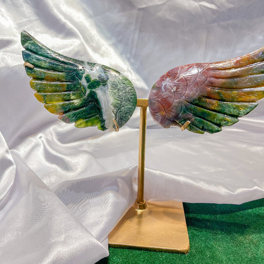 Handcrafted natural crystal healing wings sculpture on gold stand