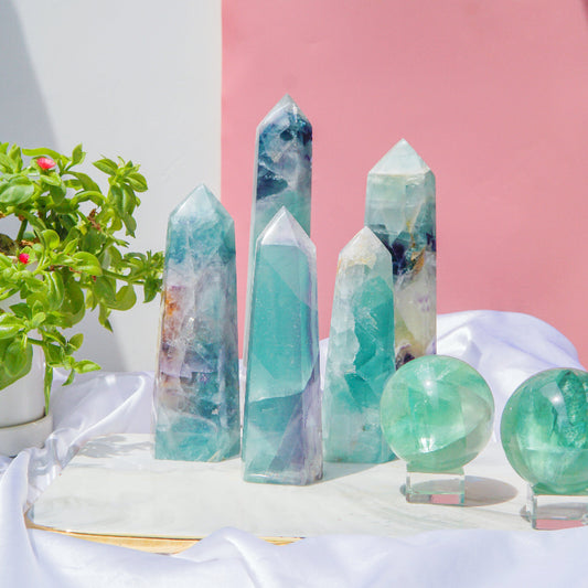 Natural fluorite crystal tower with vibrant green and purple banding