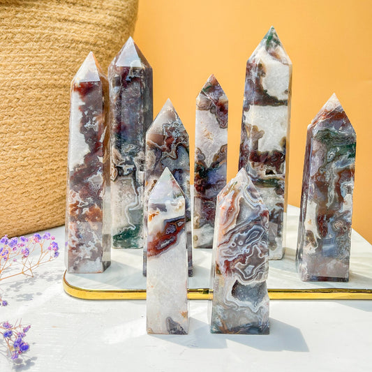 Natural moss agate crystal point with green and white swirling patterns