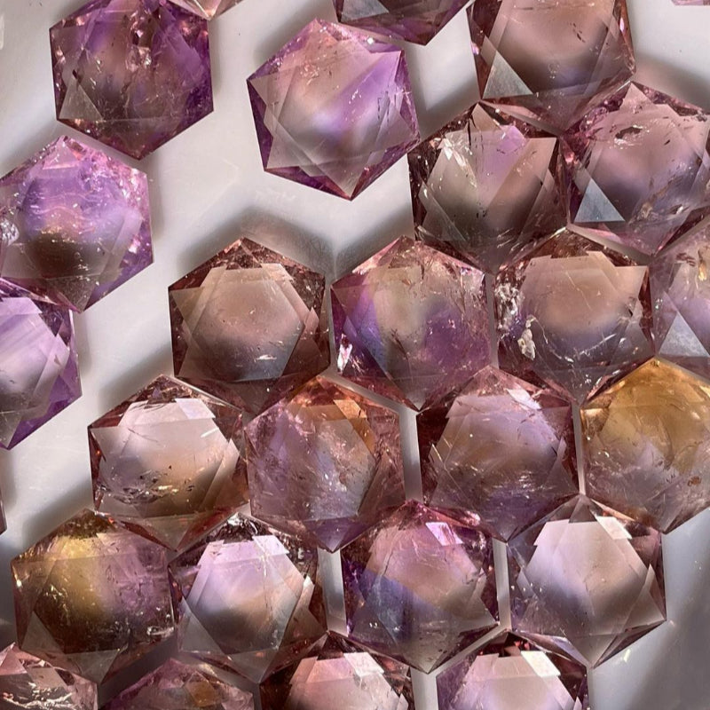 Natural ametrine gemstone with purple and gold color zones in hexagonal crystal formation