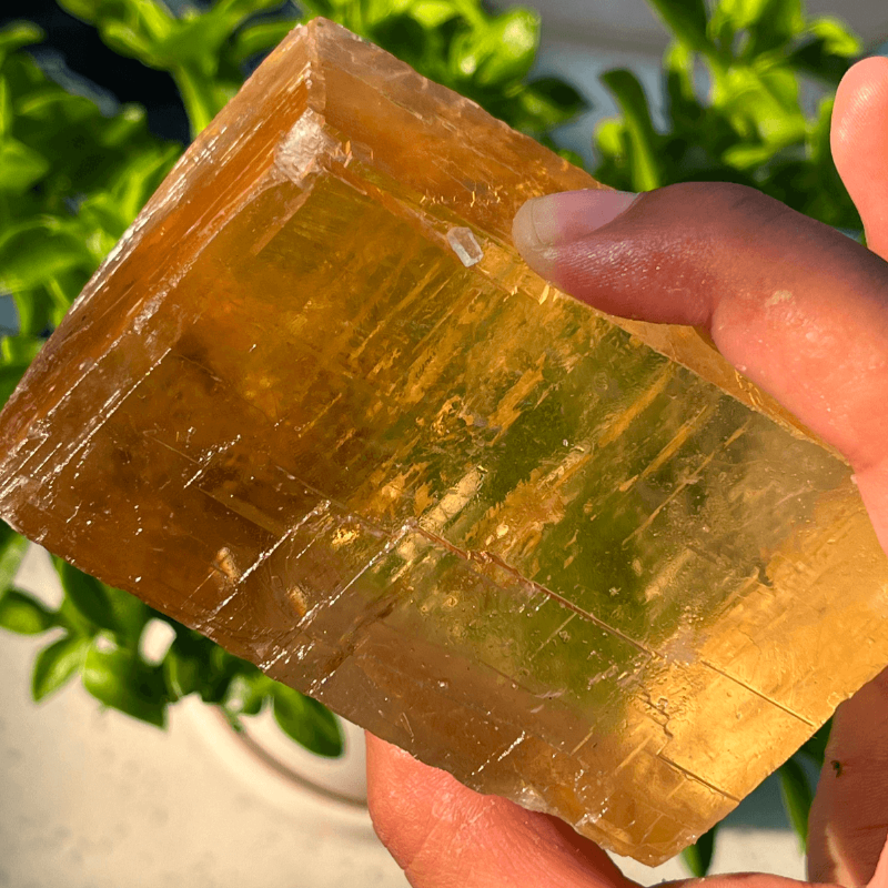Natural raw honey calcite crystal with golden amber translucent appearance