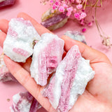 Natural raw pink tourmaline crystal specimen with vibrant rose hues