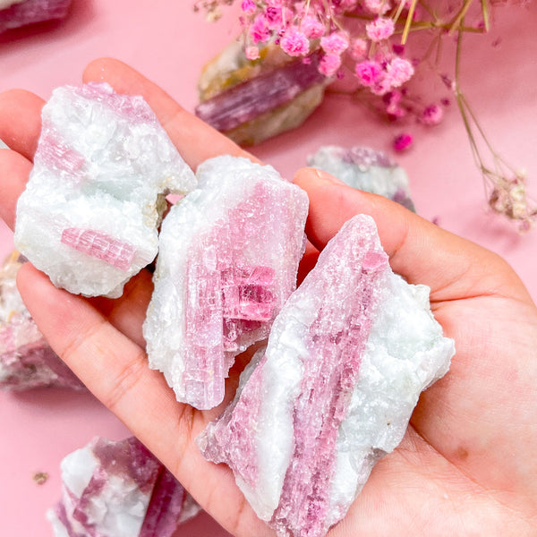 Natural raw pink tourmaline crystal specimen with vibrant rose hues