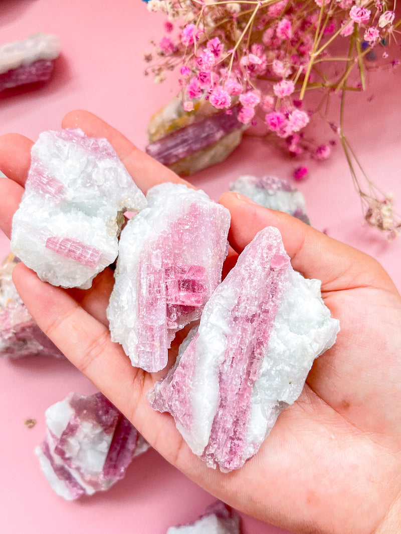 Natural raw pink tourmaline crystal specimen with vibrant rose hues