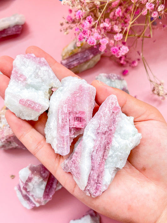 Natural raw pink tourmaline crystal specimen with vibrant rose hues