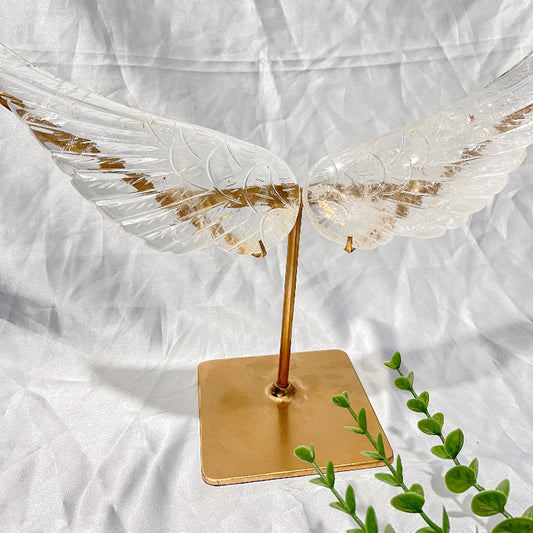 Translucent crystal wings on gold base display stand with greenery accent